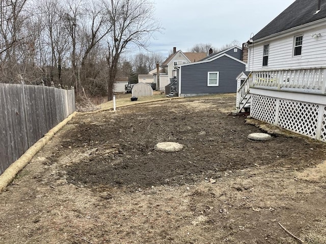 view of yard featuring a deck and fence