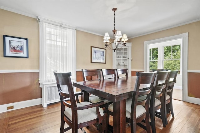 30 Wentworth Ave, Lowell, MA 01852 - dining room featuring a chandelier, light wood finished floors, baseboards, and ornamental molding
