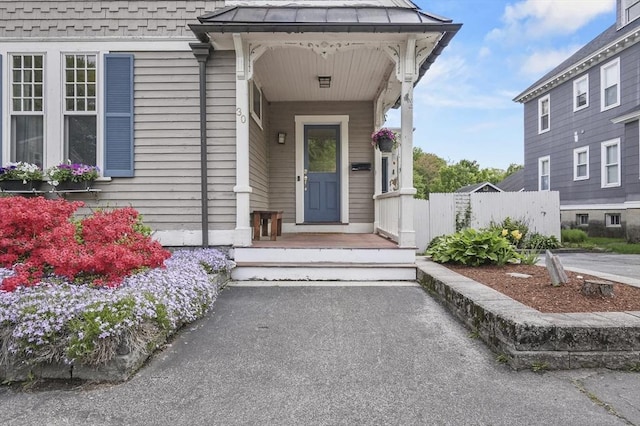 30 Wentworth Ave, Lowell, MA 01852 - view of exterior entry with fence and a standing seam roof