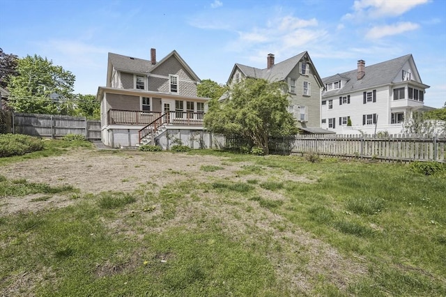 30 Wentworth Ave, Lowell, MA 01852 - rear view of property featuring a deck, stairway, and a chimney