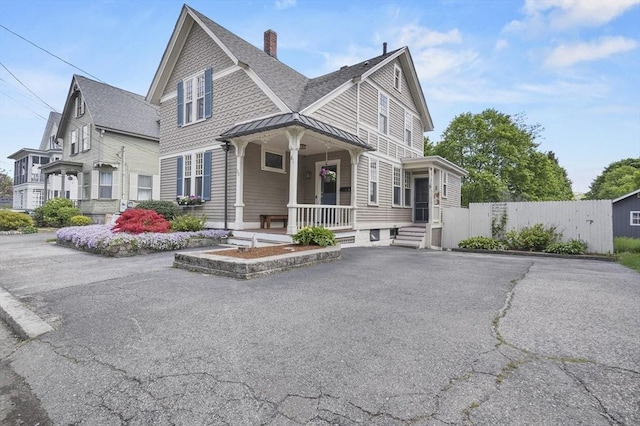 30 Wentworth Ave, Lowell, MA 01852 - view of front of property featuring a shingled roof, a standing seam roof, a porch, a chimney, and metal roof