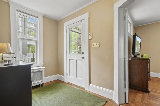 30 Wentworth Ave, Lowell, MA 01852 - entrance foyer with crown molding, baseboards, radiator heating unit, and wood finished floors