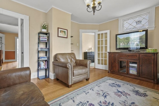 30 Wentworth Ave, Lowell, MA 01852 - living area featuring a chandelier, light wood-type flooring, crown molding, and baseboards