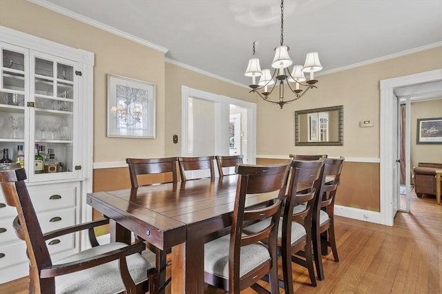 30 Wentworth Ave, Lowell, MA 01852 - dining space with a chandelier, light wood finished floors, and crown molding