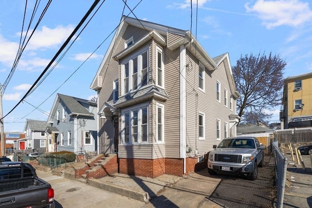 view of home's exterior featuring fence