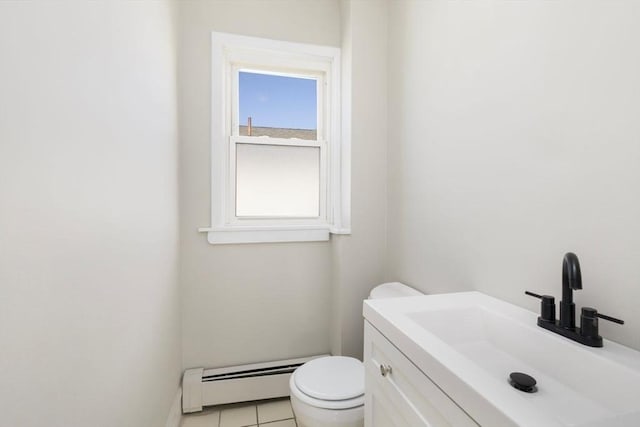 half bath featuring a baseboard heating unit, vanity, toilet, and tile patterned floors