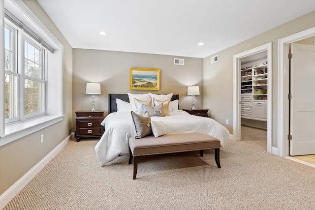 bedroom with light carpet, visible vents, recessed lighting, and baseboards