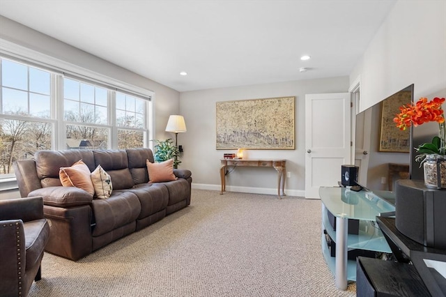 living room featuring recessed lighting, light colored carpet, and baseboards