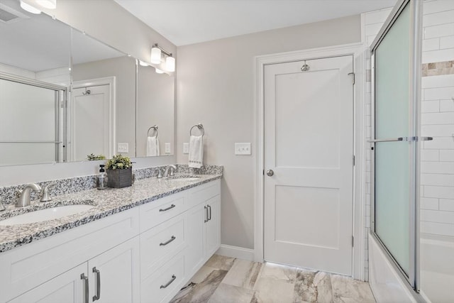 full bath with double vanity, combined bath / shower with glass door, visible vents, and a sink