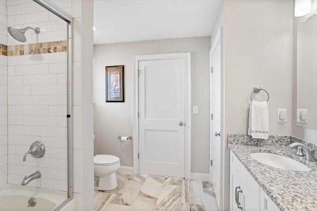 bathroom featuring shower / washtub combination, toilet, vanity, and baseboards