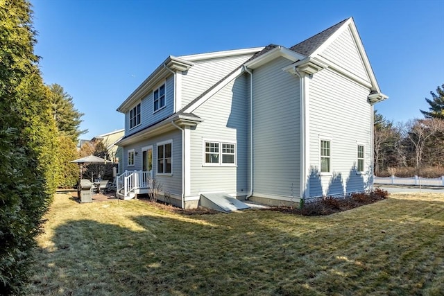 back of house with a lawn