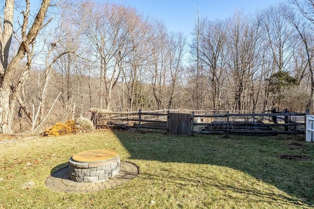 view of yard featuring a fire pit and fence