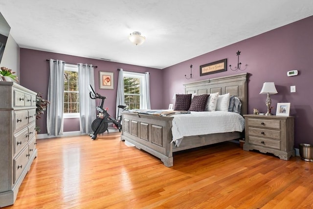 bedroom with baseboards and light wood finished floors