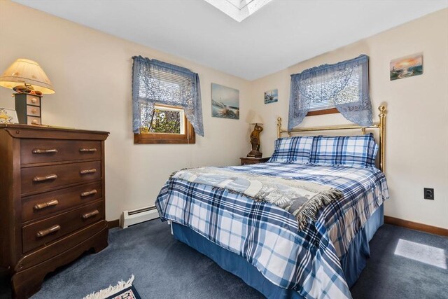 bedroom featuring baseboards, a skylight, carpet, and a baseboard radiator
