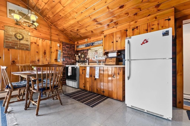 kitchen with freestanding refrigerator, wooden walls, light countertops, wooden ceiling, and vaulted ceiling