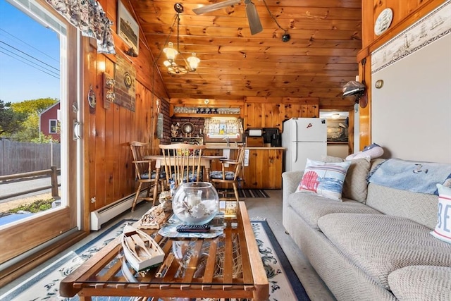living room with a baseboard heating unit, lofted ceiling, and wooden walls