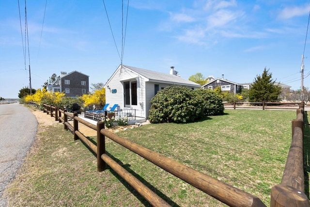 view of home's exterior featuring fence and a yard