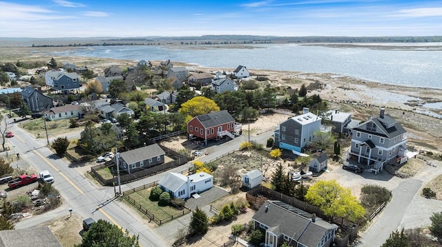 drone / aerial view with a water view and a residential view