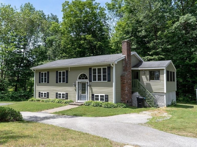 300 Henshaw St, Leicester, MA 01524 - bi-level home featuring a front yard and a chimney