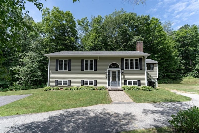 300 Henshaw St, Leicester, MA 01524 - raised ranch with a chimney and a front lawn