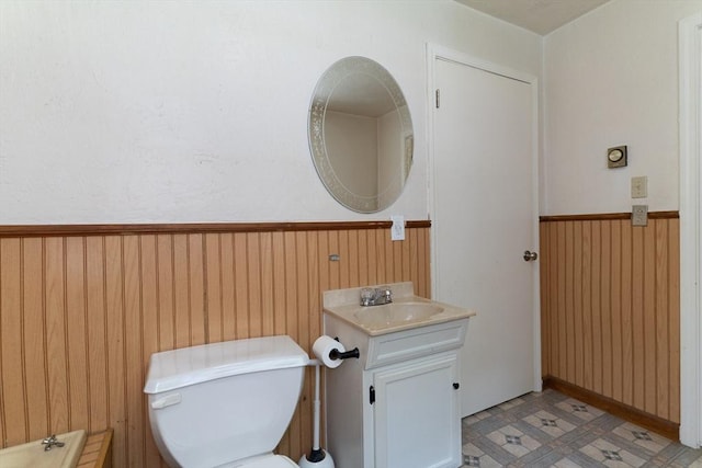 300 Henshaw St, Leicester, MA 01524 - bathroom with wainscoting, vanity, and wood walls