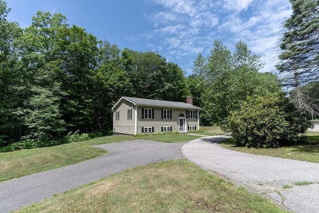 300 Henshaw St, Leicester, MA 01524 - raised ranch with a chimney, a front yard, and asphalt driveway