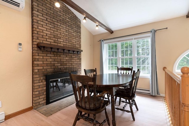 300 Henshaw St, Leicester, MA 01524 - dining area featuring a fireplace, light wood-type flooring, a wall mounted air conditioner, a baseboard heating unit, and a baseboard radiator