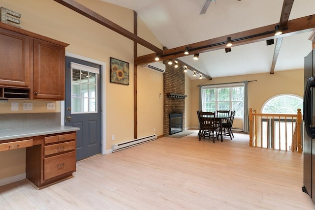 300 Henshaw St, Leicester, MA 01524 - kitchen with a baseboard heating unit, brown cabinets, a brick fireplace, light wood-style flooring, and ceiling fan
