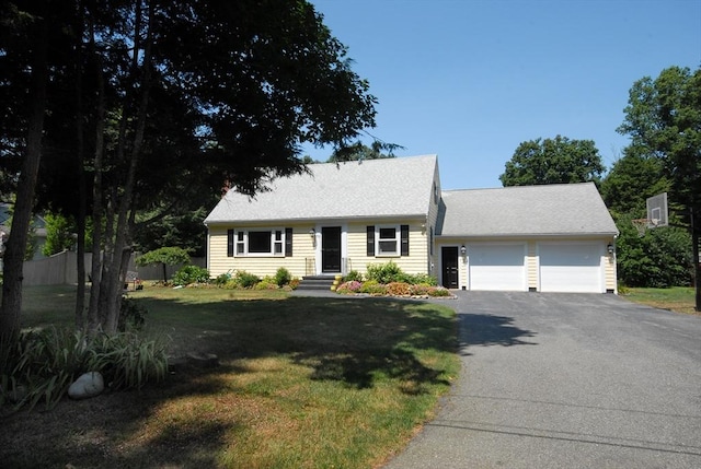 view of front of property with a garage and a front yard