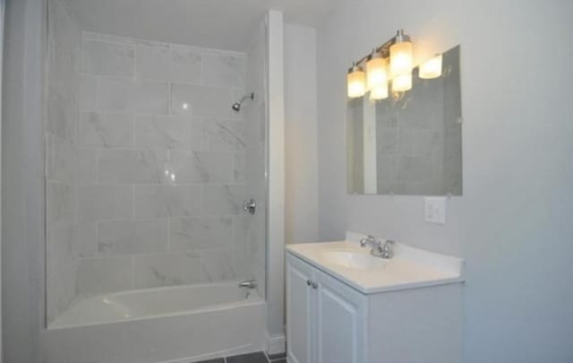 bathroom featuring washtub / shower combination and vanity