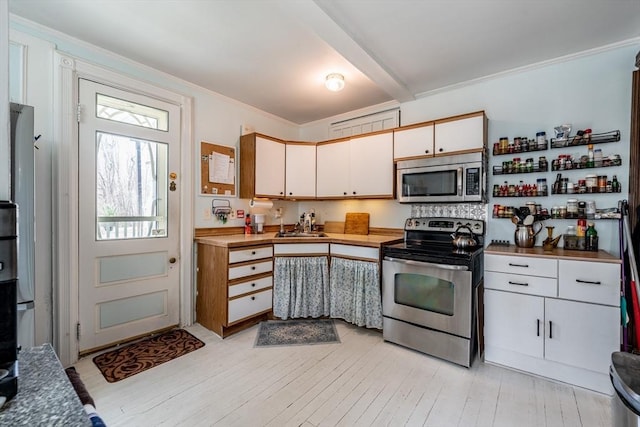 26 S Main St, Belchertown, MA 01007 - kitchen featuring light wood-style flooring, appliances with stainless steel finishes, ornamental molding, and beam ceiling