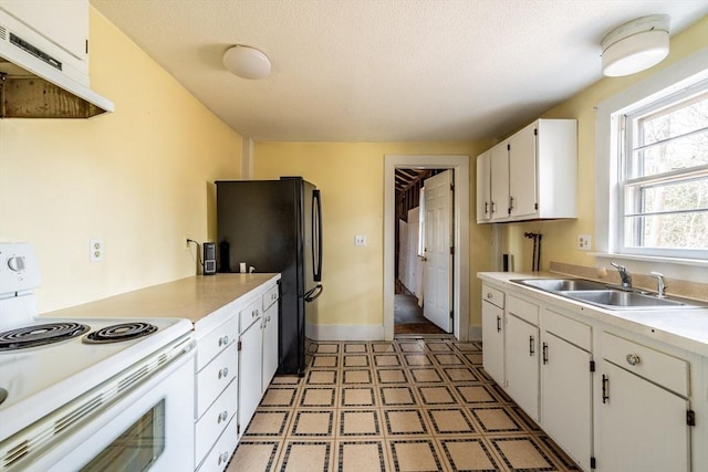 26 S Main St, Belchertown, MA 01007 - kitchen with white electric range oven, freestanding refrigerator, white cabinets, under cabinet range hood, and a sink