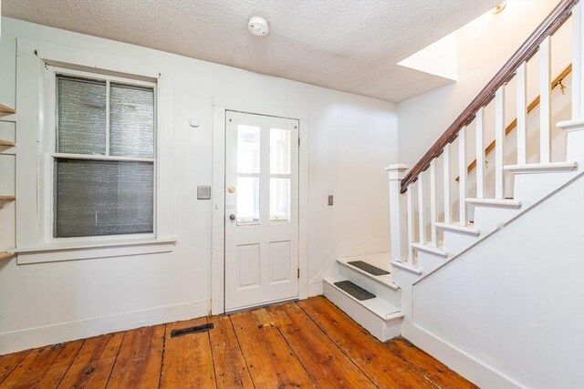 26 S Main St, Belchertown, MA 01007 - foyer entrance featuring baseboards, a textured ceiling, stairs, visible vents, and wood-type flooring