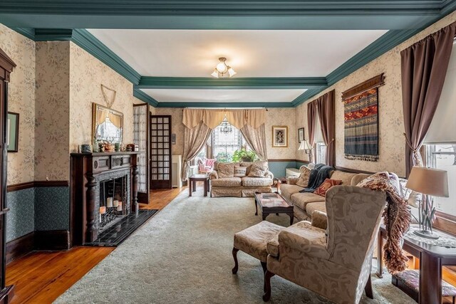 26 S Main St, Belchertown, MA 01007 - living area featuring a fireplace, ornamental molding, wood finished floors, wainscoting, and wallpapered walls
