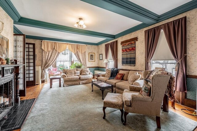 26 S Main St, Belchertown, MA 01007 - living area with crown molding, beamed ceiling, a tile fireplace, and wallpapered walls
