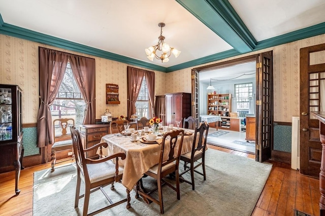 26 S Main St, Belchertown, MA 01007 - dining space featuring hardwood / wood-style floors, a notable chandelier, wallpapered walls, and a wainscoted wall