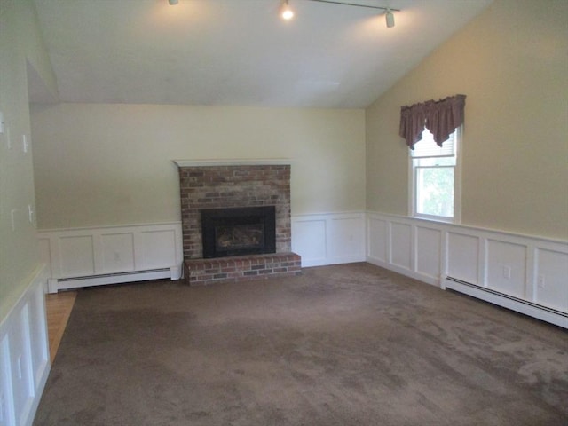 4 Deepwater Ln, Walpole, MA 02091 - unfurnished living room with a baseboard radiator, a decorative wall, vaulted ceiling, track lighting, and a brick fireplace