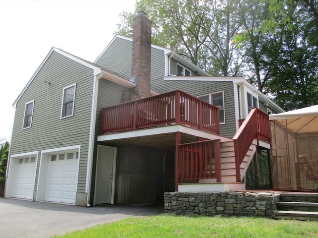 4 Deepwater Ln, Walpole, MA 02091 - rear view of property featuring a chimney, a garage, a wooden deck, driveway, and stairway