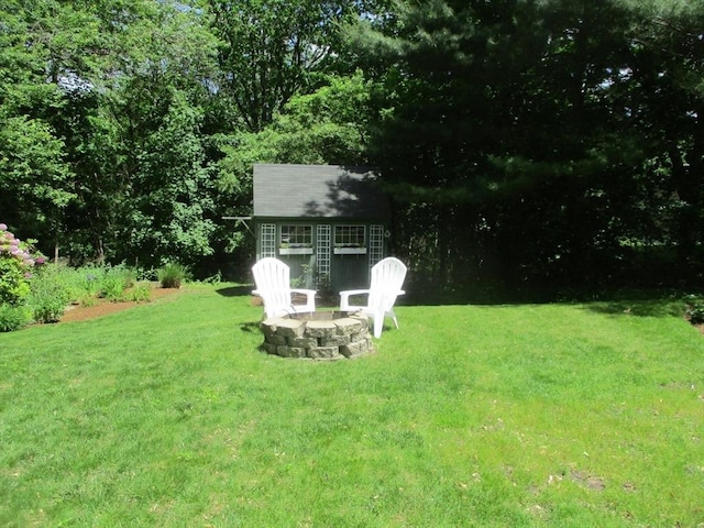 4 Deepwater Ln, Walpole, MA 02091 - view of grassy yard with an outdoor structure and a fire pit