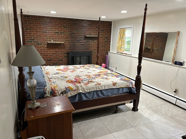 tiled bedroom featuring brick wall and a fireplace