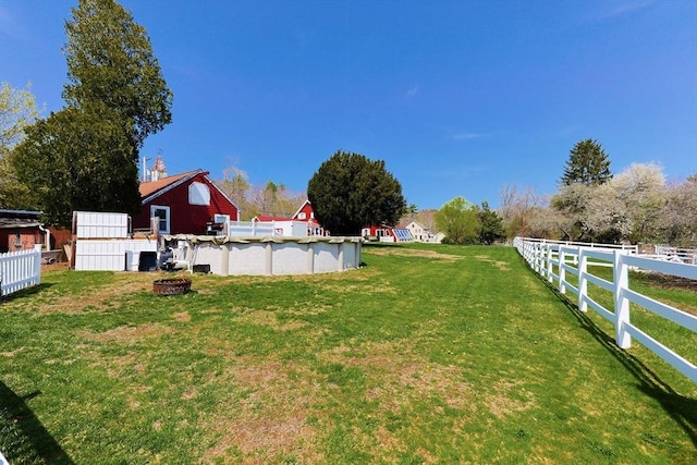 view of yard featuring fence and an outdoor pool