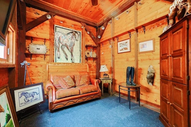 sitting room featuring wooden walls, carpet flooring, and wood ceiling