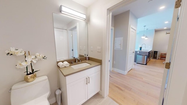 bathroom with vanity, toilet, and hardwood / wood-style floors