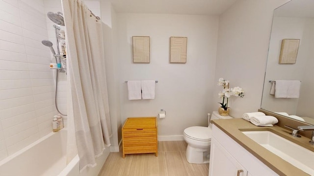 full bathroom featuring vanity, shower / bath combination with curtain, and toilet