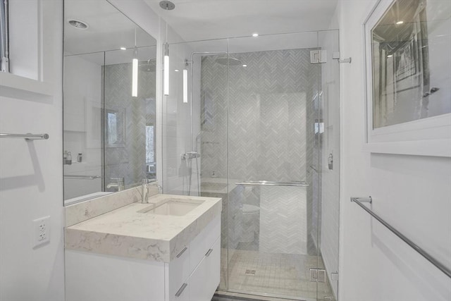 full bath featuring a stall shower and vanity