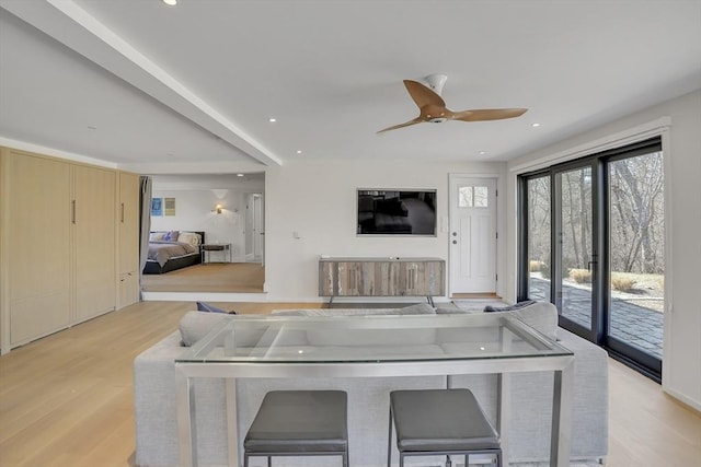 living room featuring a ceiling fan, recessed lighting, and light wood-style flooring