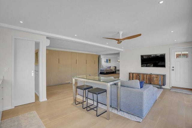 living room with light wood-style floors, ceiling fan, and recessed lighting