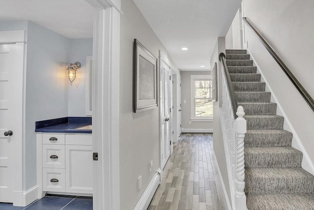 interior space featuring baseboards, wood finished floors, and recessed lighting