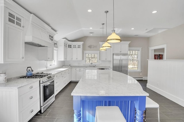 kitchen featuring tasteful backsplash, white cabinets, glass insert cabinets, vaulted ceiling, and stainless steel appliances