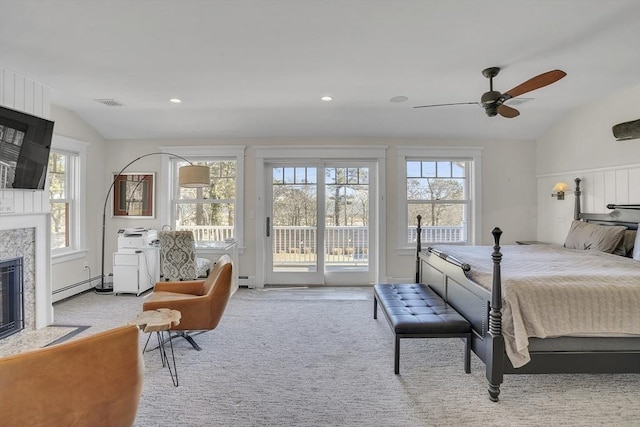 bedroom featuring lofted ceiling, carpet flooring, a high end fireplace, access to outside, and baseboard heating